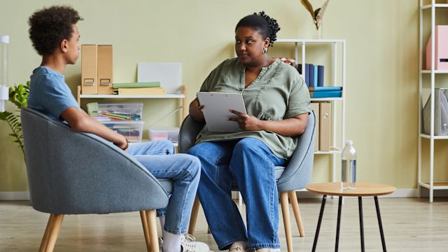 A young person with bipolar disorder speaks with a counselor. Treatment for bipolar disorder can involve several healthcare providers working as a team.