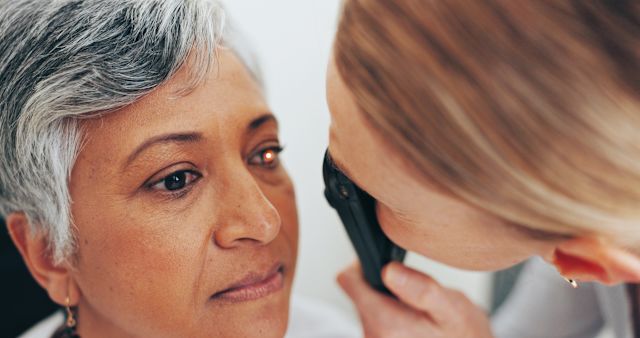 mature woman receiving eye exam from ophthalmologist
