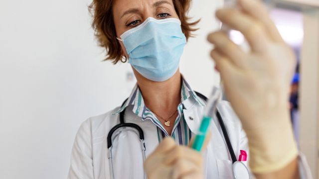 An oncologist prepares an injection of a subcutaneous immunotherapy. Subcutaneous immune checkpoint inhibitors are one of several immunotherapies used in the treatment of melanoma.