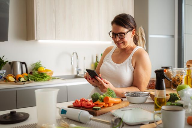 woman in kitchen tracking her eating habits