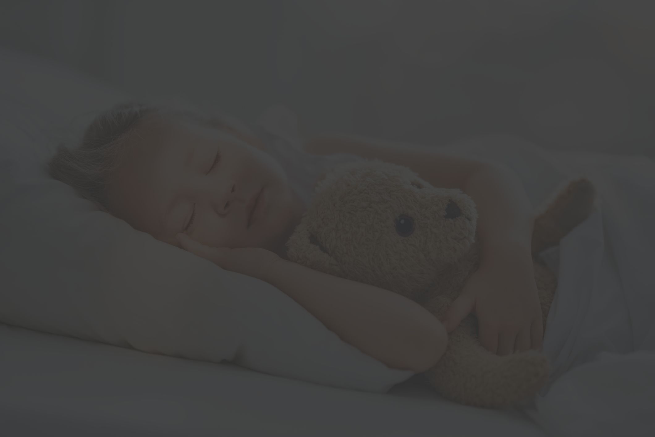 little girl sleeping with teddy bear