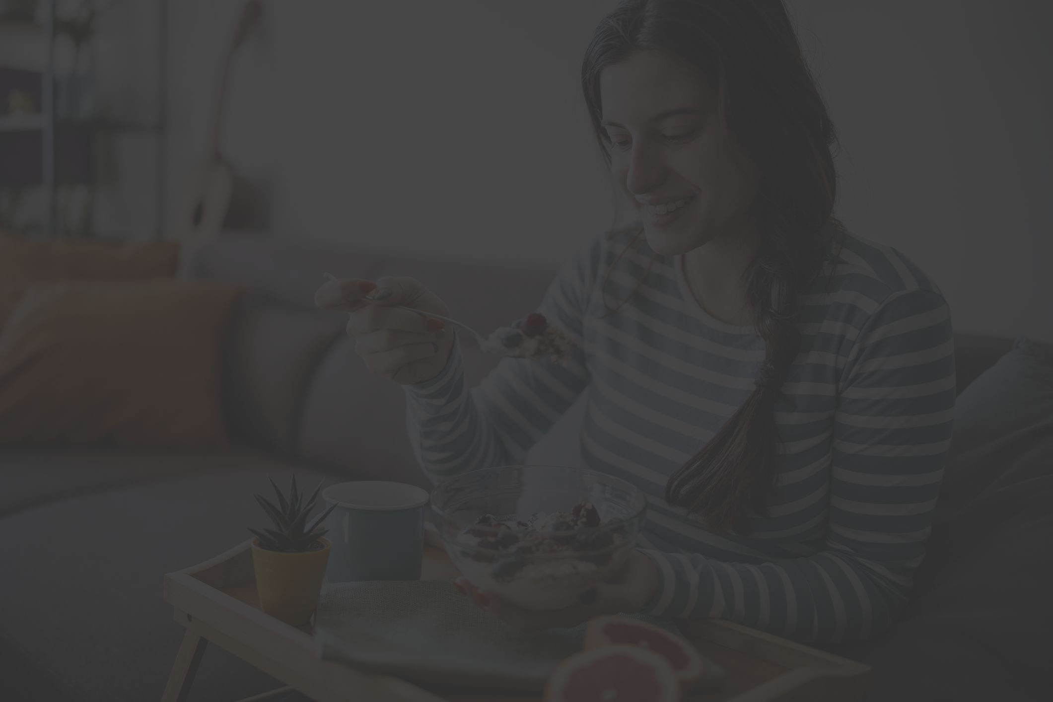 woman eating healthy breakfast with blueberries