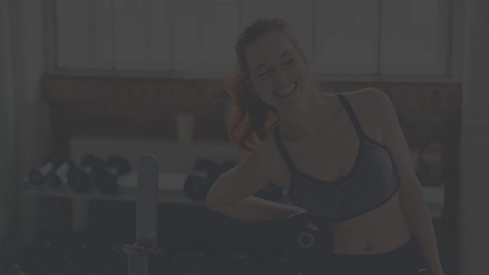 woman laughing in a weight room