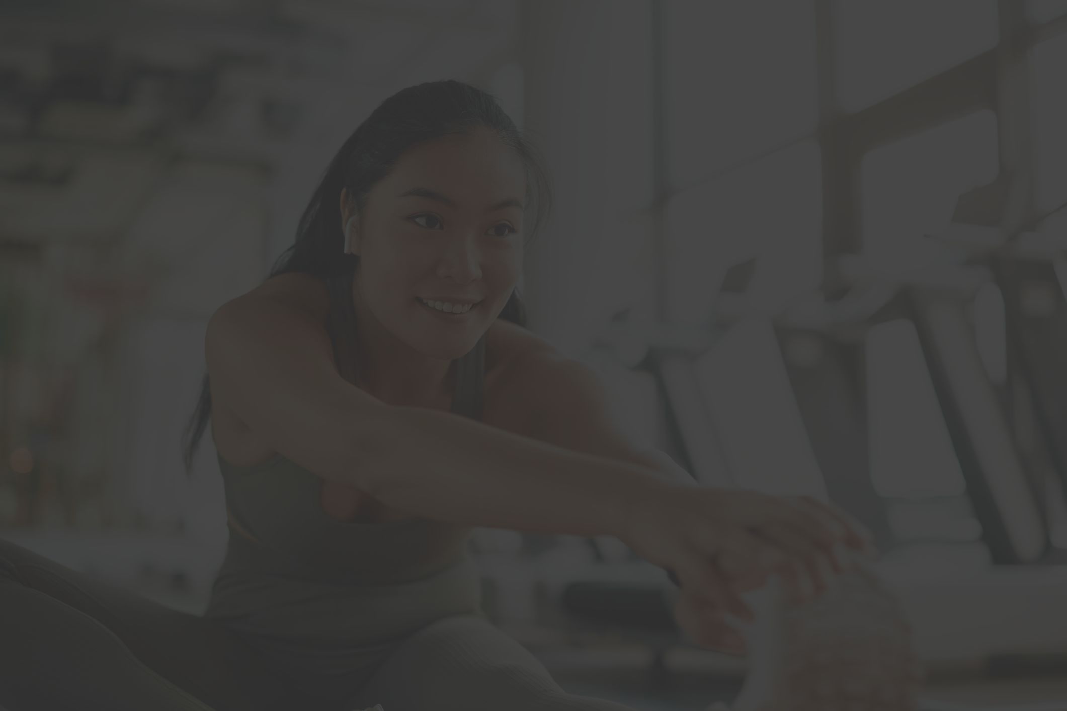 healthy young woman stretching at the gym