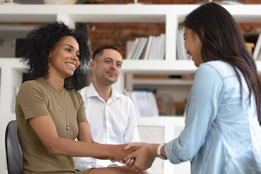 Businesswoman shaking hands with a team member