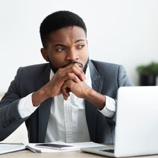 Man at his desk considering his next move.