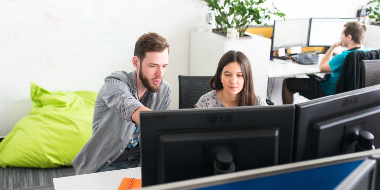 Developers consulting at a computer